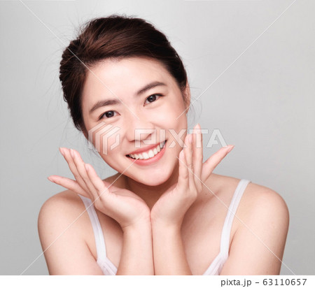 young beautiful asian woman with clean and bright skin, Cosmetic Beauty Concept,smiling face 63110657