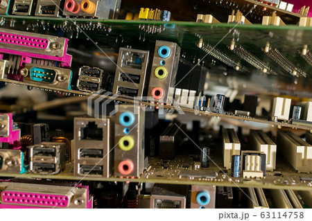 close up, old electronic motherboards from computers are lying in a pile close up, old electronic motherboards from computers are lying in a pile 63114758