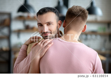 Two young men hugging each other and feeling great 63116654