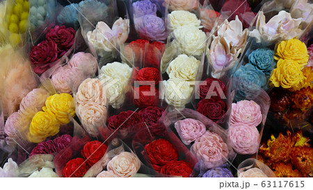 A variety of colorful flowers wrapped in transparent wrappers. View from above. A variety of colorful flowers wrapped in transparent wrappers. View from above. 63117615