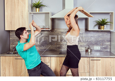 Young couple are fighting in the kitchen. Young couple are fighting in the kitchen. 63117755