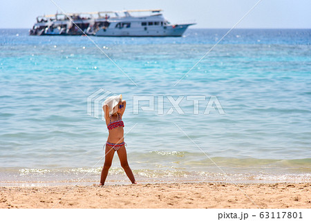 Little girl in a swimsuit poses for the Little girl in a swimsuit poses for the 63117801