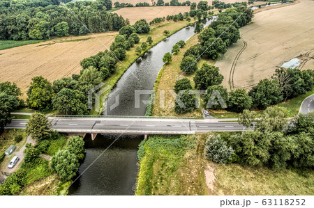 Aerial photo of a small river with a bridge 63118252