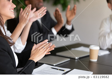 Close up overjoyed female male coworkers applauding. Close up overjoyed female male coworkers applauding. 63119682