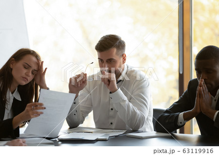 Mixed race frustrated group of employees feeling unmotivated. Mixed race frustrated group of employees feeling unmotivated. 63119916