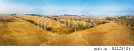 Panorama of empty plowed field in early spring. 63122433