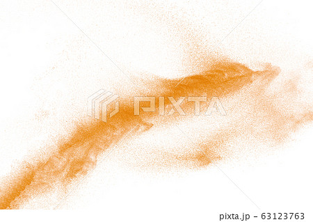 Orange powder dust particles explosion on white Orange powder dust particles explosion on white 63123763