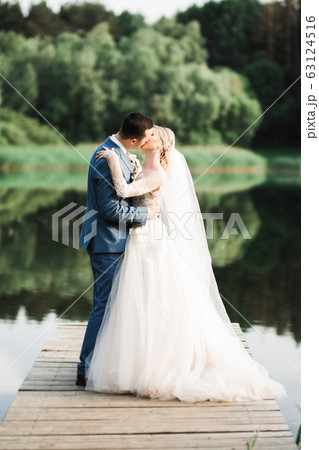 Romantic wedding moment, couple of newlyweds smiling portrait, bride and groom hugging Romantic wedding moment, couple of newlyweds smiling portrait, bride and groom hugging 63124516