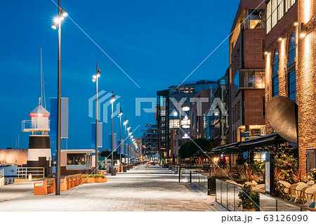 Oslo, Norway. Night View Embankment And Residential Multi-storey Houses In Aker Brygge District. Summer Evening. Residential Area Reflected In Sea Waters. Famous And Popular Place Oslo, Norway. Night View Embankment And Residential Multi-storey Houses In Aker Brygge District. Summer Evening. Residential Area Reflected In Sea Waters. Famous And Popular Place 63126090
