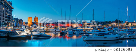 Oslo, Norway. Night View Embankment, Oslo City Hall And Moored Yachts Near Aker Brygge District. Summer Evening. Famous And Popular Place Oslo, Norway. Night View Embankment, Oslo City Hall And Moored Yachts Near Aker Brygge District. Summer Evening. Famous And Popular Place 63126093