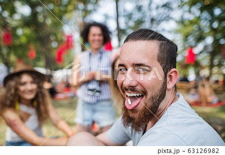 Group of young friends at summer festival, drug dealing concept. Group of young friends at summer festival, drug dealing concept. 63126982