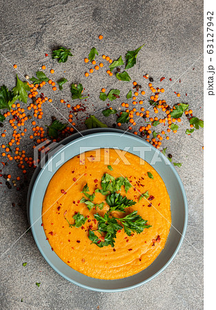 Traditional Indian soup lentils. Indian Dhal spicy curry in bowl, spices, herbs, rustic grey wooden background. Authentic Indian dish. Close-up. Top view. 63127942