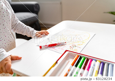Baby toddler at daycare or home paining with felt tip pens. 63128234