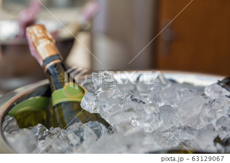 Sparkling wine bottle in ice bucket 63129067