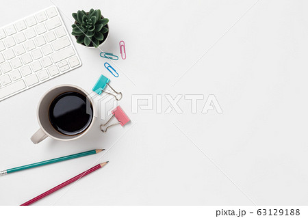 Top view, Workspace desk With coffee and office supplies on white background Top view, Workspace desk With coffee and office supplies on white background 63129188