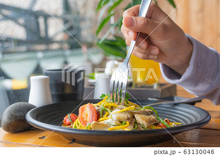 Eatting pasta with fork 63130046