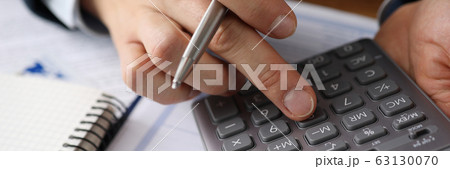 Man analyzes cost renting, counting on calculator 63130070