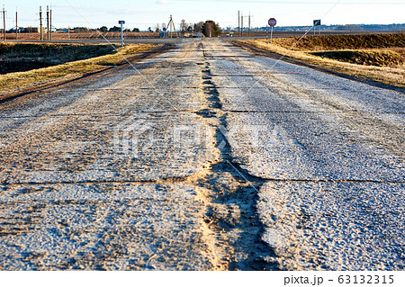 Dangerous asphalt road with holes destroyed. 63132315