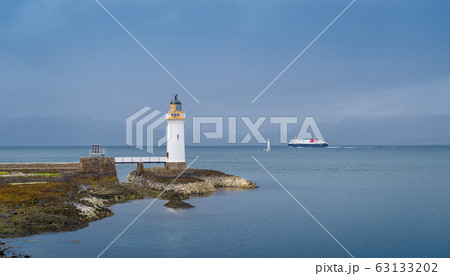 Sea traffic and lighthouse at the north of Mull island, Scotland. Sea traffic and lighthouse at the north of Mull island, Scotland. 63133202