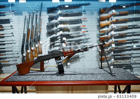 Retro rifle with a drum magazine, gun shop Retro rifle with a drum magazine, gun shop 63133409