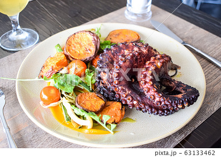 Octopus with vegetables, seafood dish 63133462