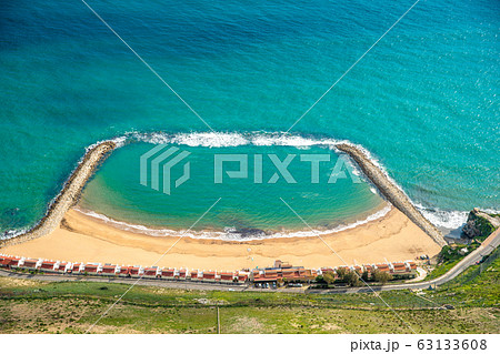 beach on ocean coast with barriers to protect against waves and water predators beach on ocean coast with barriers to protect against waves and water predators 63133608