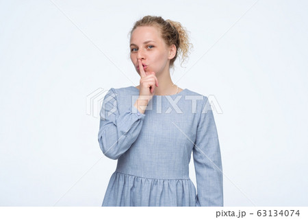 Be silent, it is secret. Female asks to keep secret information confidential Be silent, it is secret. Female asks to keep secret information confidential 63134074