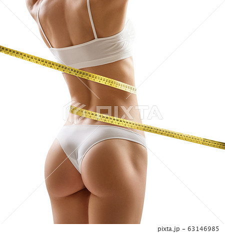 Muscular young woman athlete with measuring tape. Sport concept. Muscular young woman athlete with measuring tape. Sport concept. 63146985