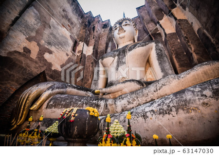 Old buddha statue on wall in ancient temple Old buddha statue on wall in ancient temple 63147030