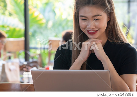 Beautiful Attractive Asian woman working with computer laptop Beautiful Attractive Asian woman working with computer laptop 63147398