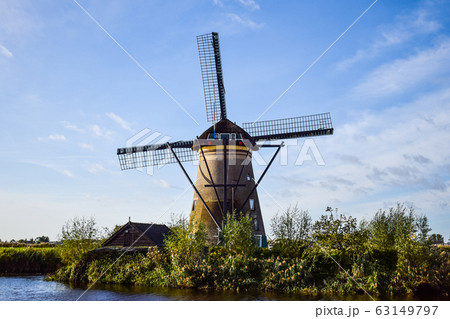 Old Dutch windmill. Blue sky background. Old Dutch windmill. Blue sky background. 63149797