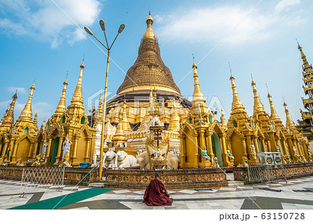 Buddhist monk sitting and meditation in front of Shwedagon pagoda an iconic landmark in downtown of Yangon, Myanmar. Buddhist monk sitting and meditation in front of Shwedagon pagoda an iconic landmark in downtown of Yangon, Myanmar. 63150728