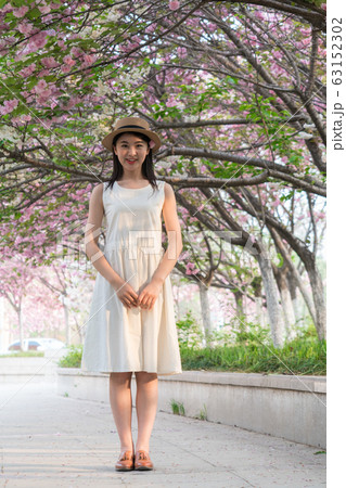 beautiful girl and cherry blossom 63152302