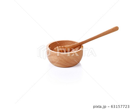 Wooden honey scoop isolated on white background Wooden honey scoop isolated on white background 63157723