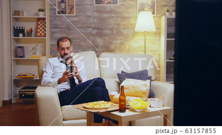 Tired businessman after long day of work 63157855
