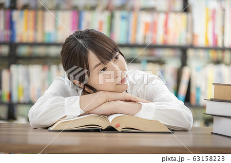 若い女性　うつ伏せ　考え事 63158223