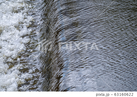 A small flat cascade in a calm river A small flat cascade in a calm river 63160622