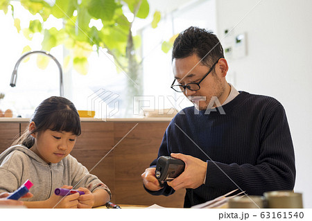 手廻し充電式ライトの使い方を学ぶ家族 63161540
