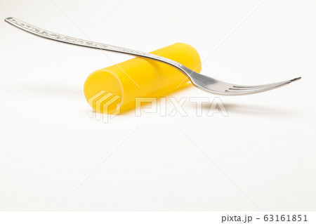 Cannelloni pasta and the fork on the white table. Cannelloni pasta and the fork on the white table. 63161851