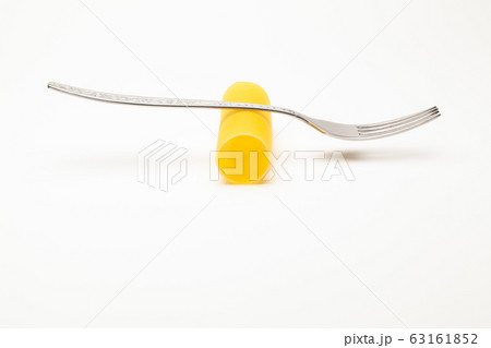 Cannelloni pasta and the fork on the white table. Cannelloni pasta and the fork on the white table. 63161852