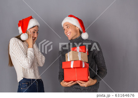 Young couple studio isolated on grey wall concept 63164676
