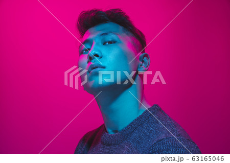 Portrait of a guy with colorful neon light on pink background - cyberpunk concept 63165046