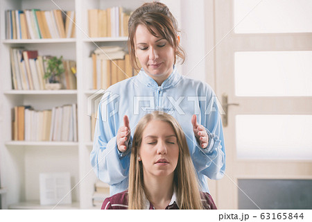 Professional Reiki healer doing reiki Professional Reiki healer doing reiki 63165844