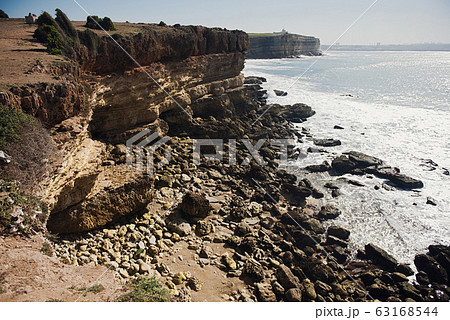 beautiful rugged coastline with waves crashing against the cliffs 63168544