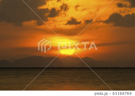 Sunset sky at the lake with clouds and silhouette Sunset sky at the lake with clouds and silhouette 63168769