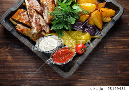 Barbecue on the bones with vegetables and potatoes . catering menu 63169481