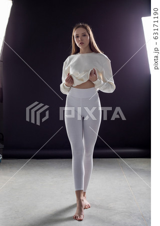 Girl in white blank leggings. Mock-up. Girl in white blank leggings. Mock-up. 63171190