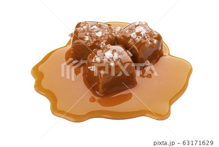 Toffee candies with caramel sauce and salt isolated on white background Toffee candies with caramel sauce and salt isolated on white background 63171629
