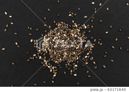 Pile of chia seeds on black background, top view Pile of chia seeds on black background, top view 63171640