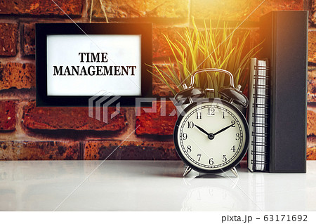 TIME MANAGEMENT text with alarm clock, books and TIME MANAGEMENT text with alarm clock, books and 63171692